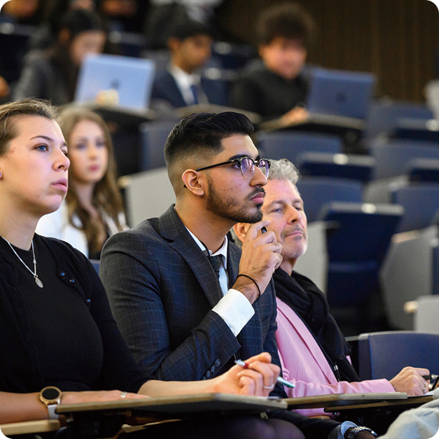 Conference attendees listening to a talk